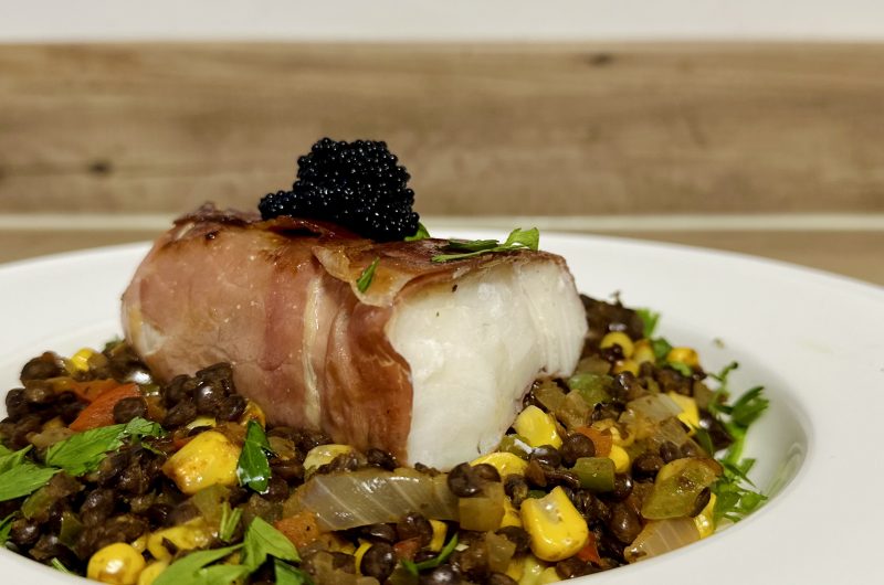 Prosciutto wrapped cod with puy lentil, sweetcorn and peppers